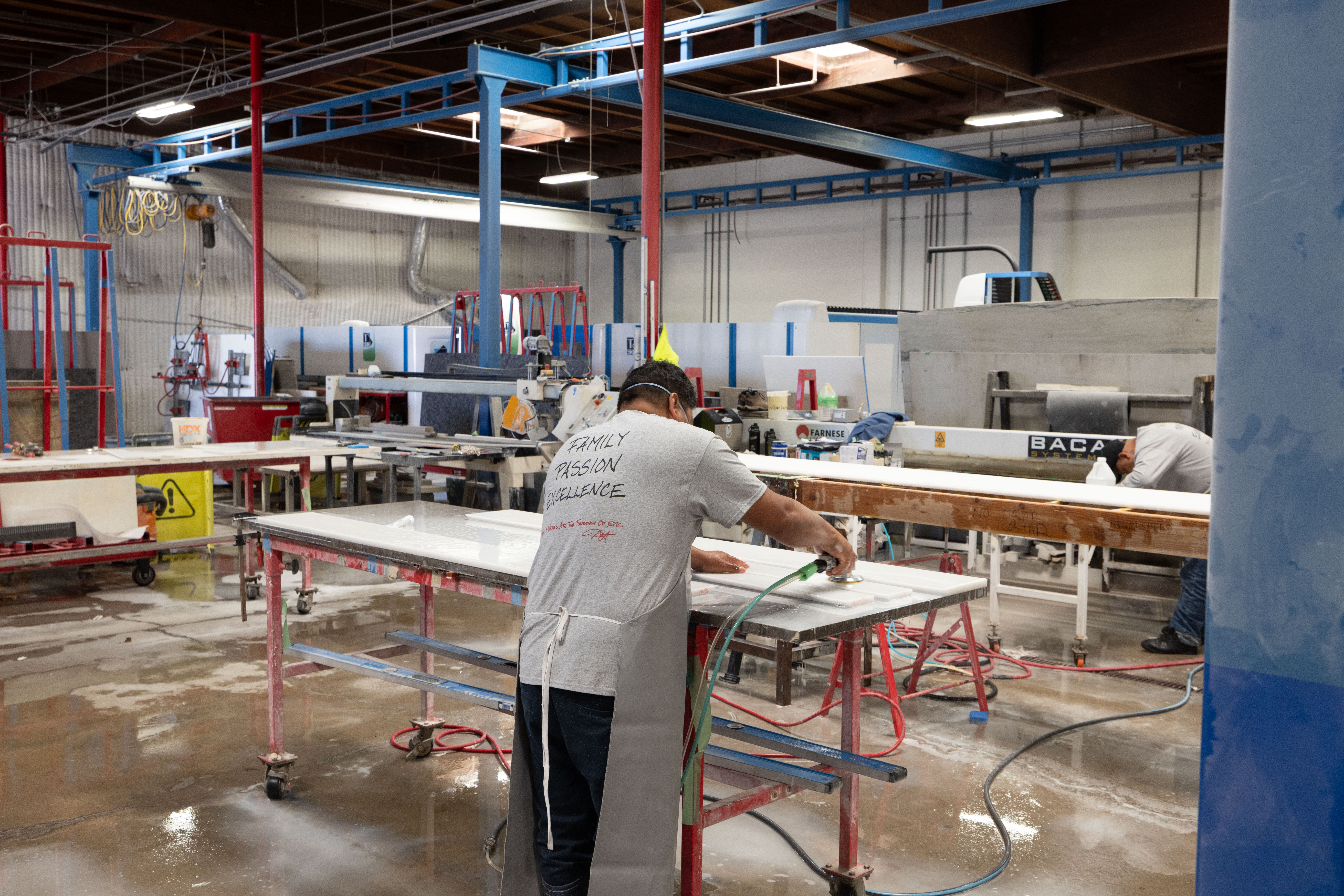 Epic Ceramic & Stone fabrication specialist preparing custom stone surfaces at the company's Orange County fabrication facility.