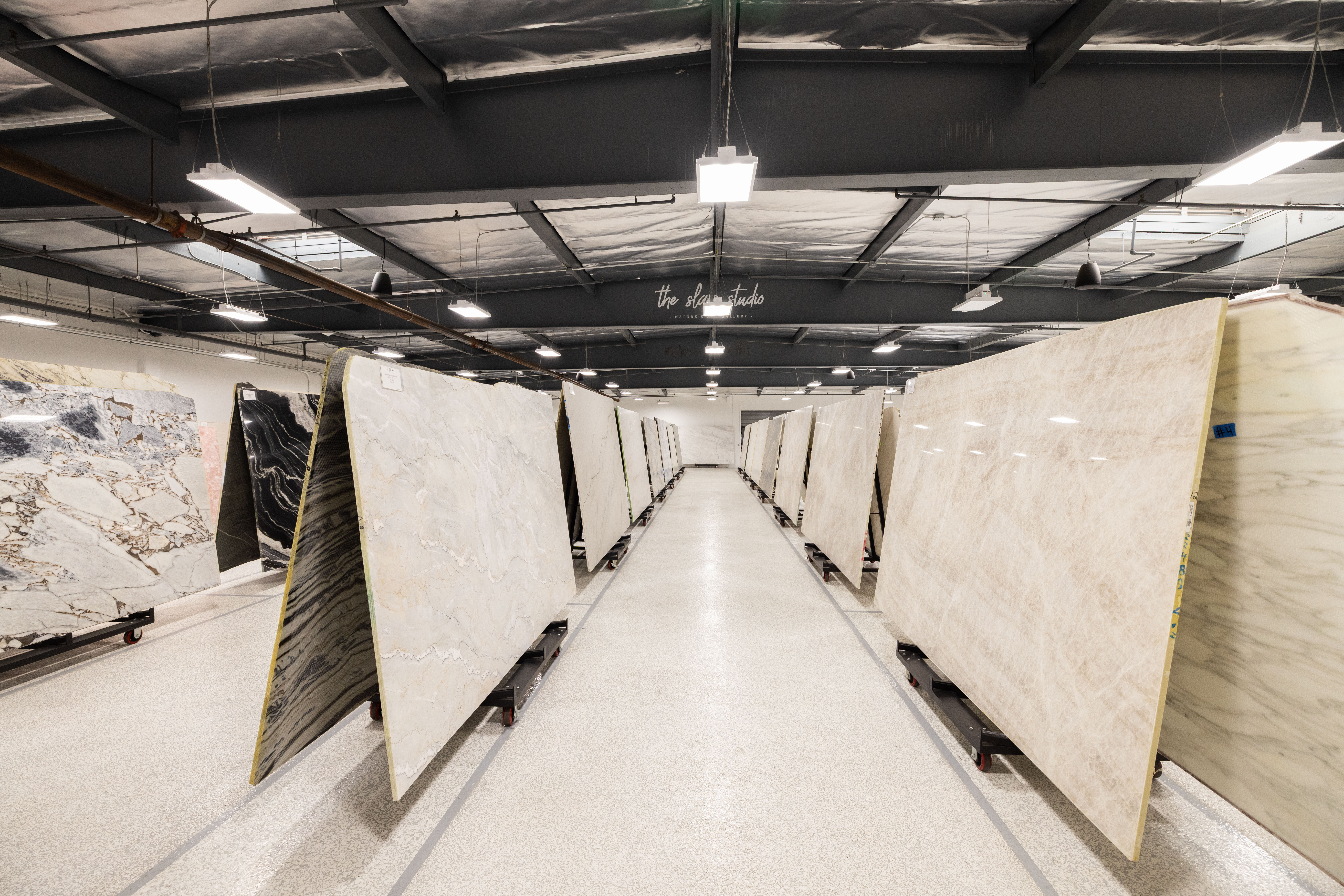 Natural stone slabs stored at Epic Ceramic & Stone's fabrication facility in Orange County.