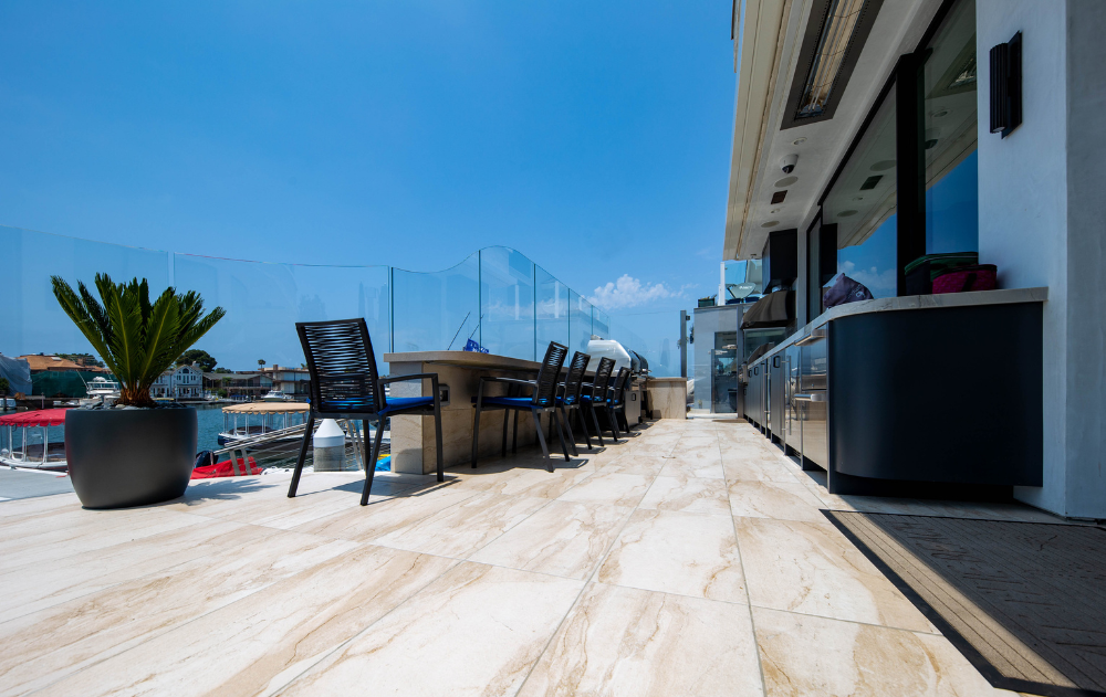 Outdoor kitchen and porcelain tile patio overlooking the waterfront