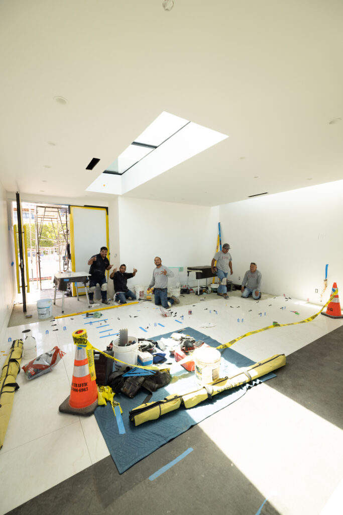 Epic Ceramic & Stone team installing premium stone finishes in a luxury Orange County custom home.