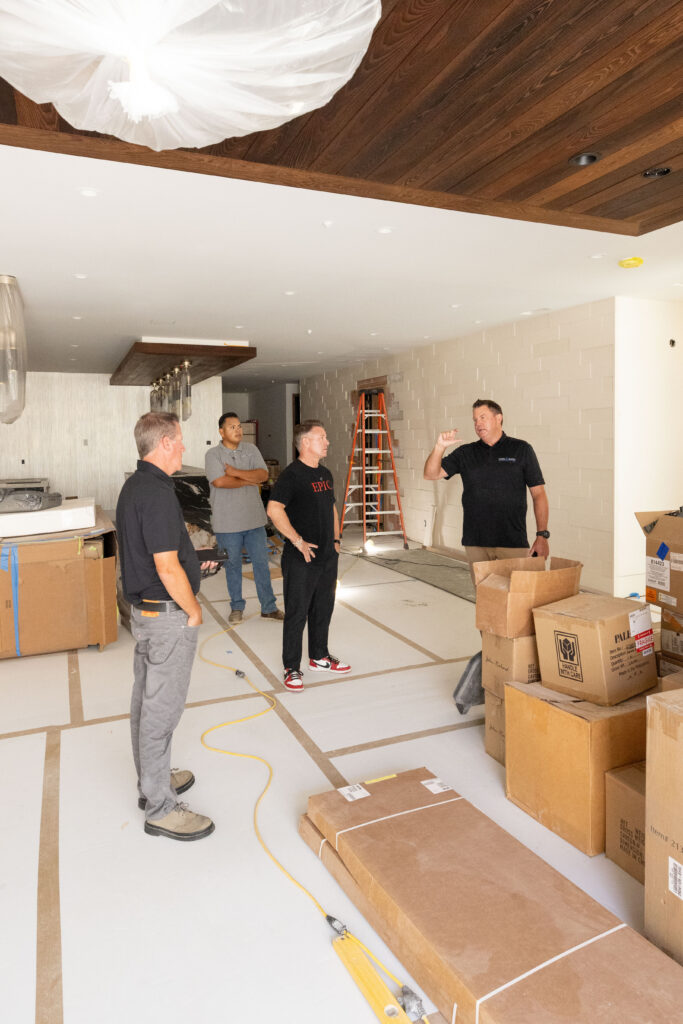 Josiah Lilly consults with his team during a luxury residential stone and tile installation project in Orange County.