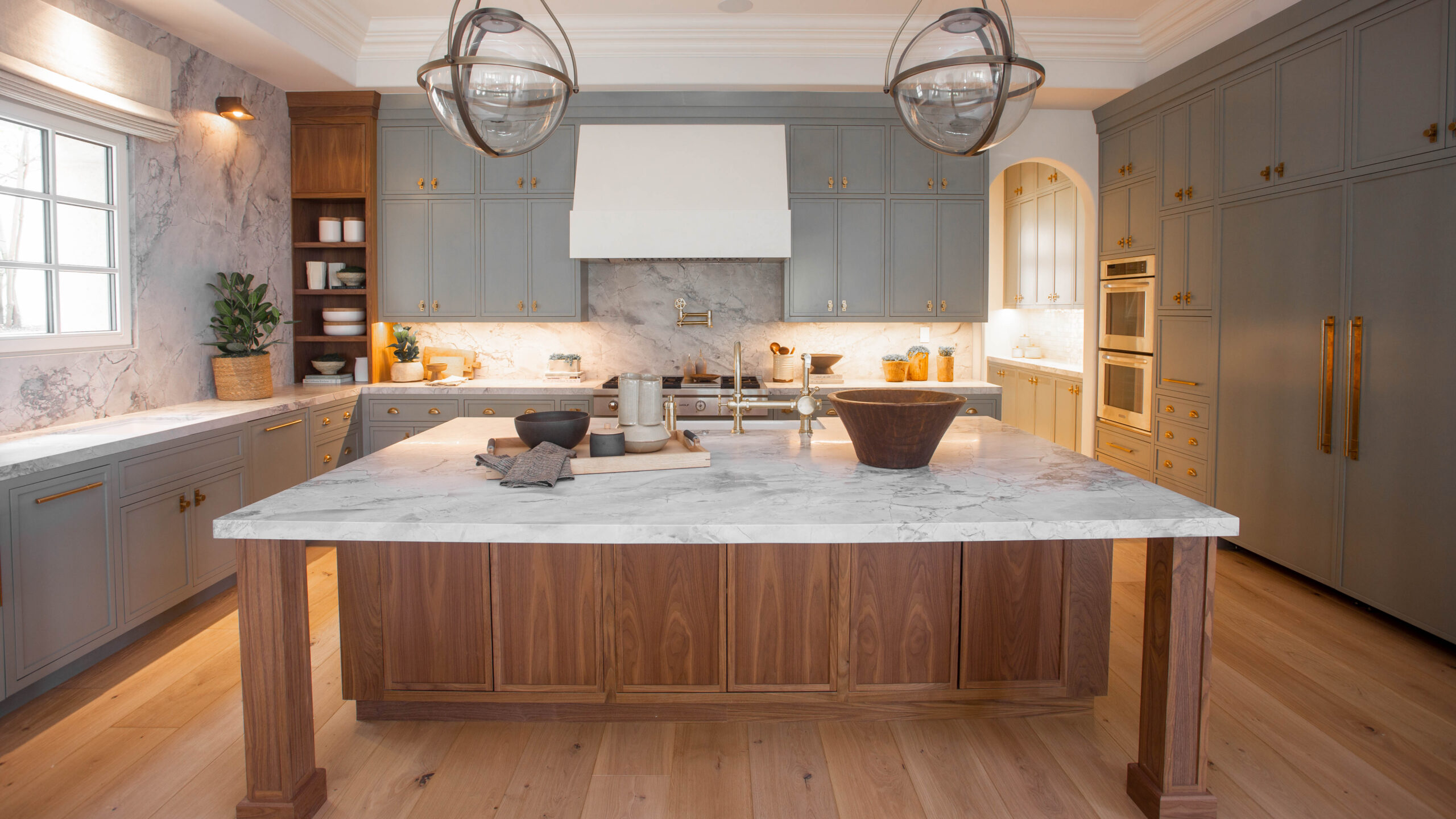 Luxury natural stone kitchen island with custom cabinetry in an Orange County home installed by Epic Ceramic & Stone.