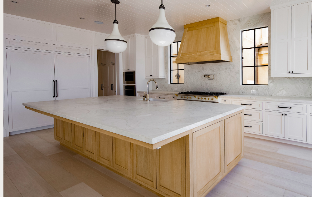 Warm-toned quartzite kitchen countertop in a luxury Orange County home featuring natural stone and warm wood cabinetry.