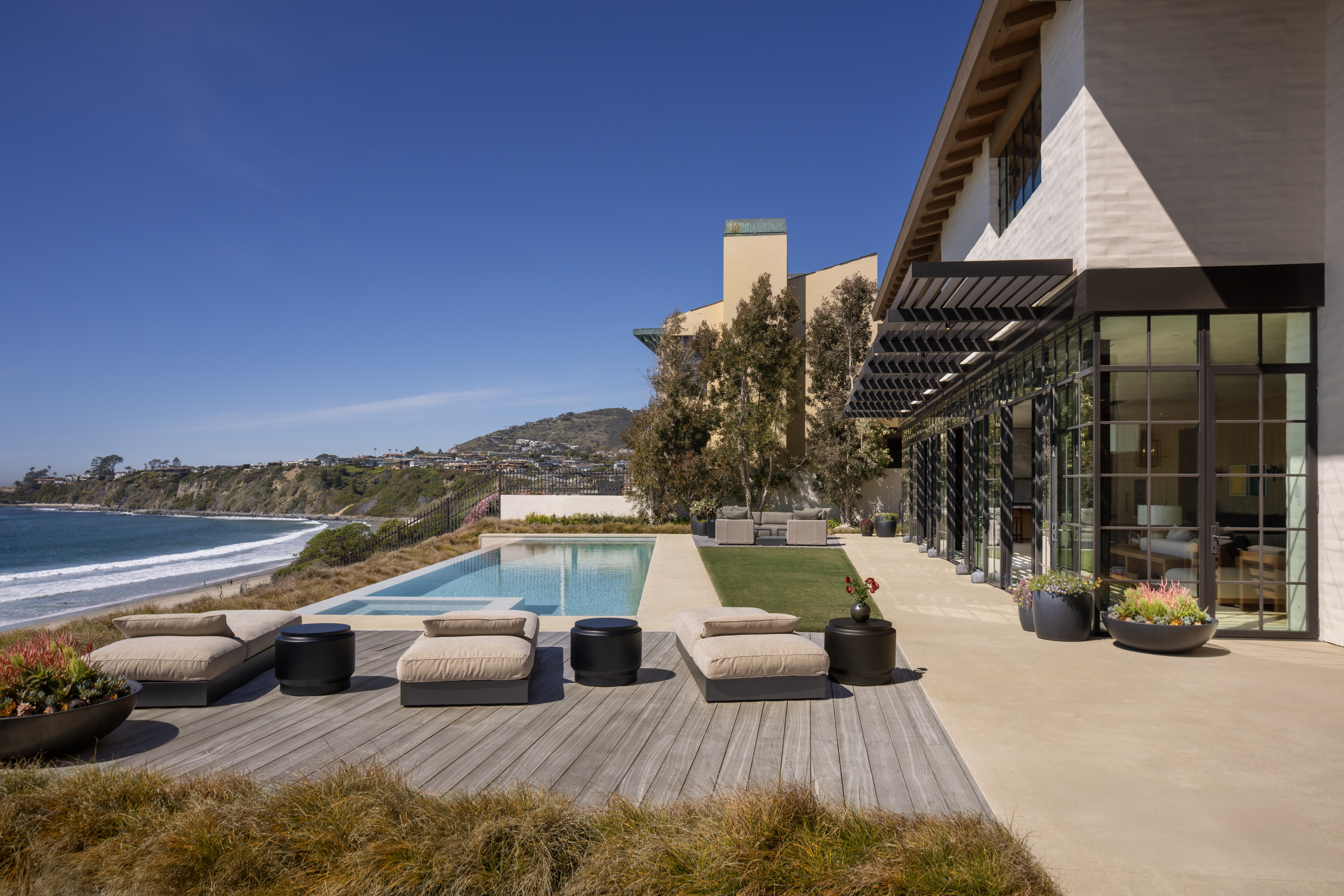 Large-format porcelain and natural travertine pool deck installation in a Southern California outdoor living space.